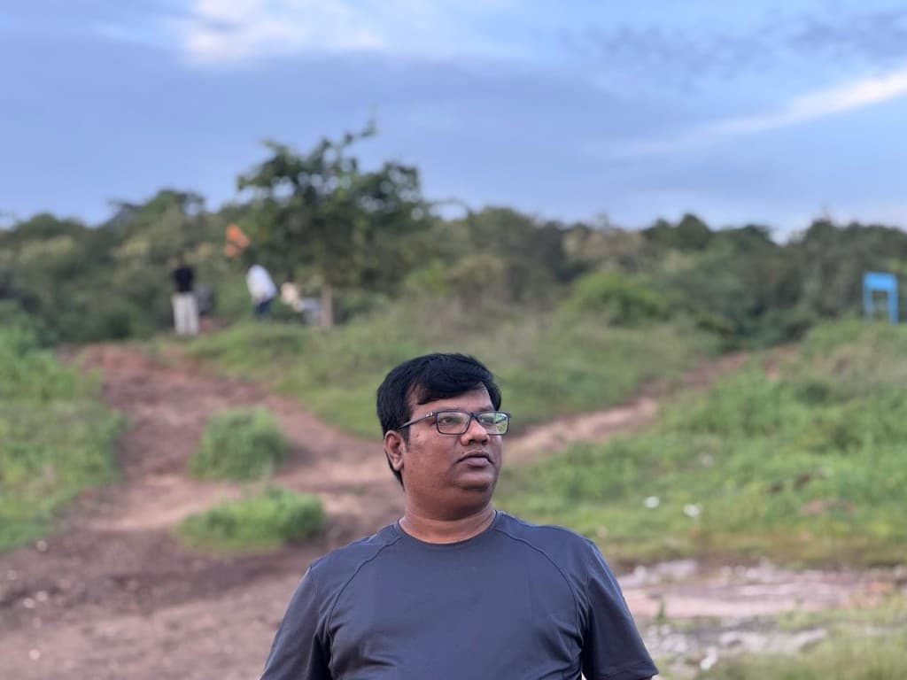 Portrait of Niladri Prasad Padhy outdoors at dusk